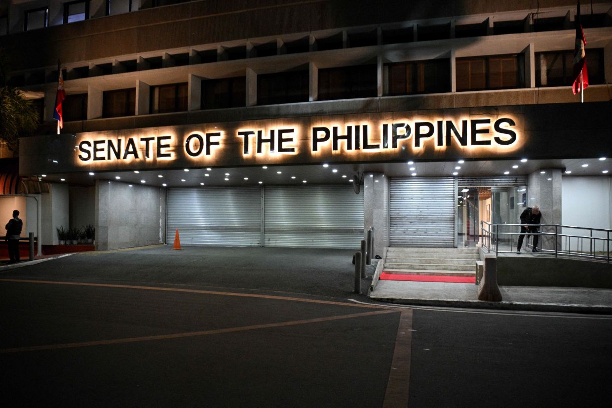Armed Senate security personnel stand guard at the entrance of the Senate building in Manila on May 13, 2026 after gunshots were heard inside the Senate building. Multiple gunshots were heard late on May 13 inside the Philippine Senate, where a senator wanted by the International Criminal Court has sought refuge, AFP journalists said. - Photo: AFP