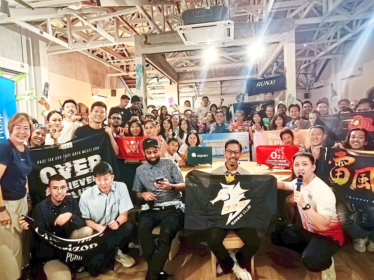 Wong posing with running club members during the PBIM dialogue session. — Handout 