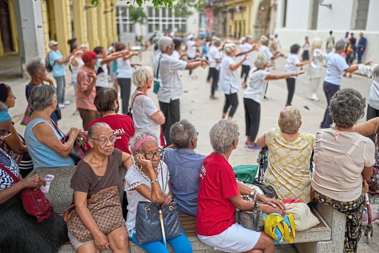Elderly residents watch a tai chi class for seniors at the Belen Convent in Old Havana. — AP