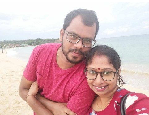 Journalist Purujoththaman Thangamayl, and his wife Mathurabhasini Thamilmaran, a lawyer, both 40, from Colombo, Sri Lanka, cut a cake to celebrate actor Vijay's party winning the Tamil Nadu state assembly election in India. -COURTESY OF PURUJOTHTHAMAN THANGAMAYL