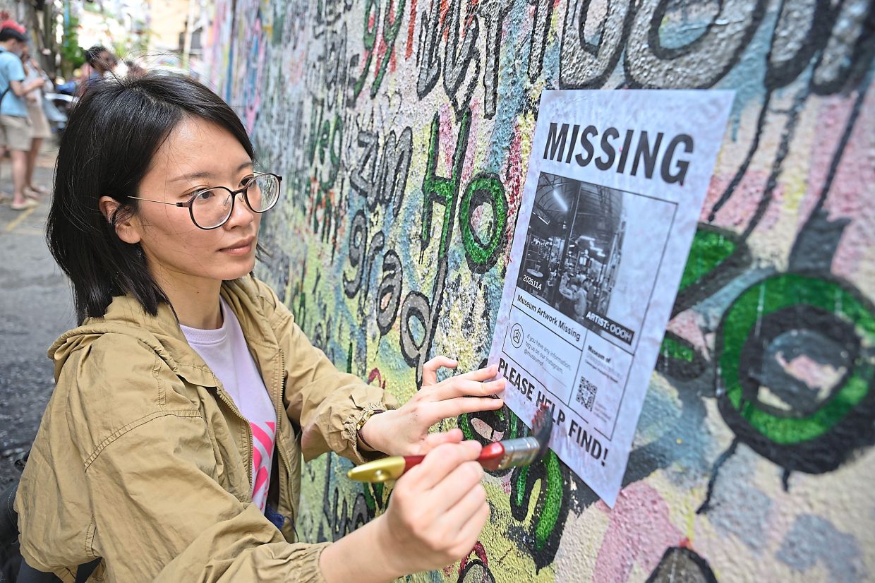 Ho puts up a ‘Missing’ sign to create awareness for the project.