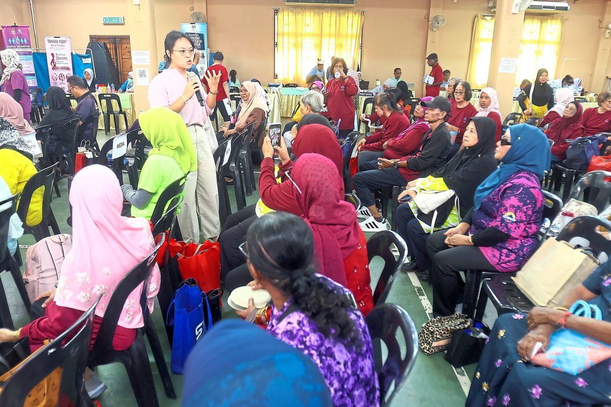 Participants getting health and nutritional advice during a talk. (Right) There are also booths by various agencies and strategic partners, including physiotherapy providers.