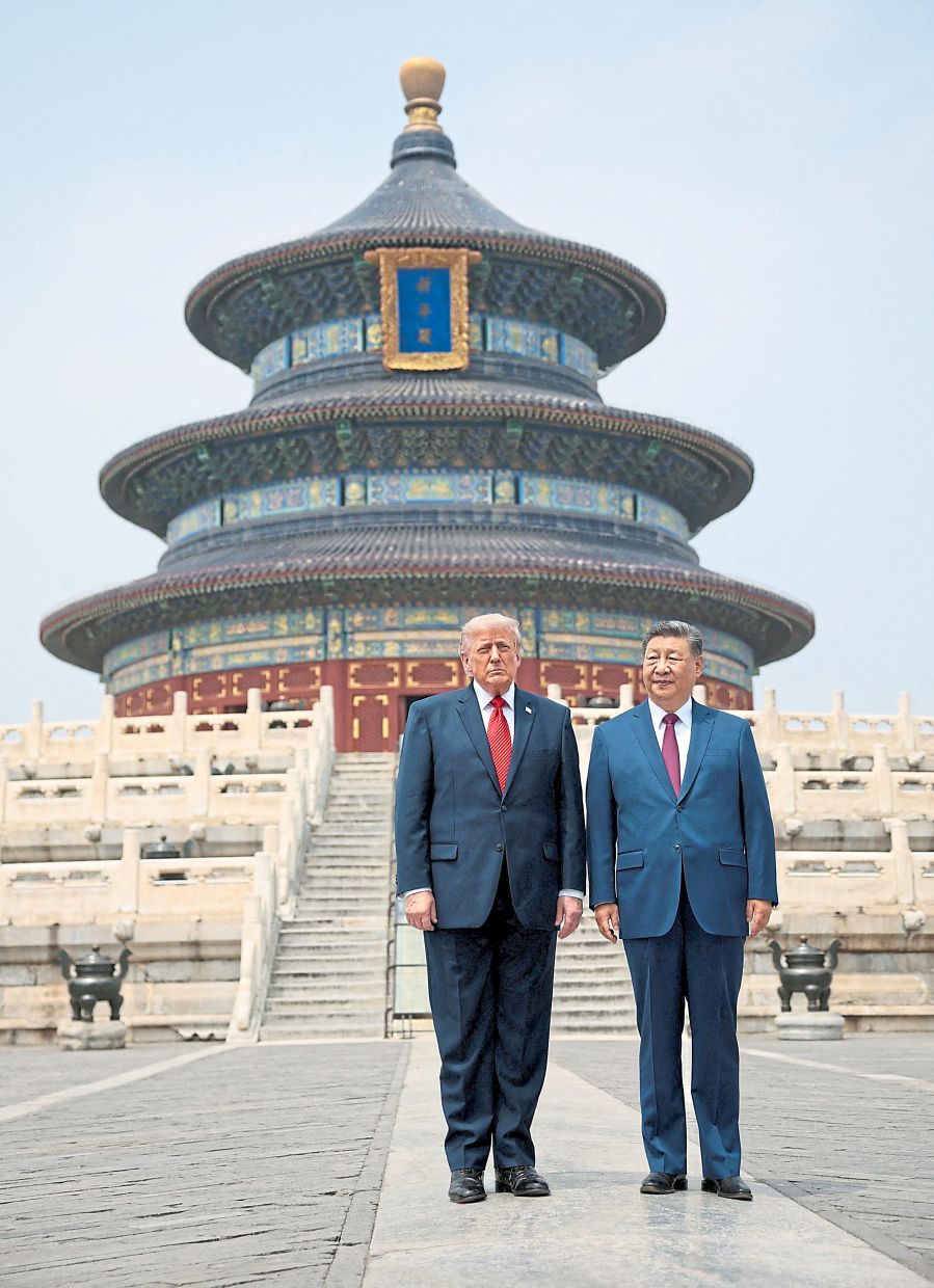 High-stakes visit: (From top to bottom) Trump and Xi standing together as they tour the Temple of Heaven in Beijing; (middle row from right) Musk and Apple CEO Tim Cook are among a group of CEOs in the US delegation; and onlookers using their mobile phones as they watch a motorcade believed to be carrying Trump along Chang’an Avenue in Beijing. — Reuters/AP 