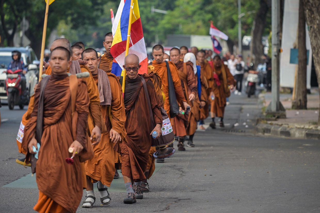 A group of Buddhist monks takes part in the Walk For Peace 2026 in Surabaya on Friday, May 15, 2026. A total of 56 monks from Indonesia, Malaysia, Thailand, and Laos travelled on a sacred journey from the island of Bali to Borobudur Temple, a distance of 660km, carrying a message of tolerance, universal peace, and social harmony ahead of the Wesak festival on May 31, 2026. -- Photo by JUNI KRISWANTO / AFP