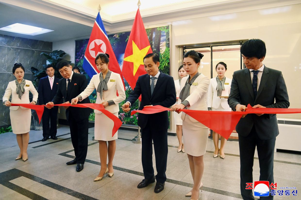 In this photo provided by the North Korean government, Vietnam's Foreign Minister Le Hoai Trung (centre) attends a photo exhibit and friendship meeting in Pyongyang, North Korea. Independent journalists were not given access to cover the event depicted in this image distributed by the North Korean government. -- Korean Central News Agency/Korea News Service via AP