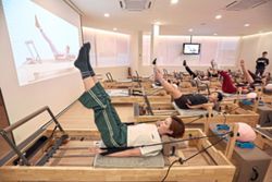 Performing Pilates with heat from Japanese Hinoki wood