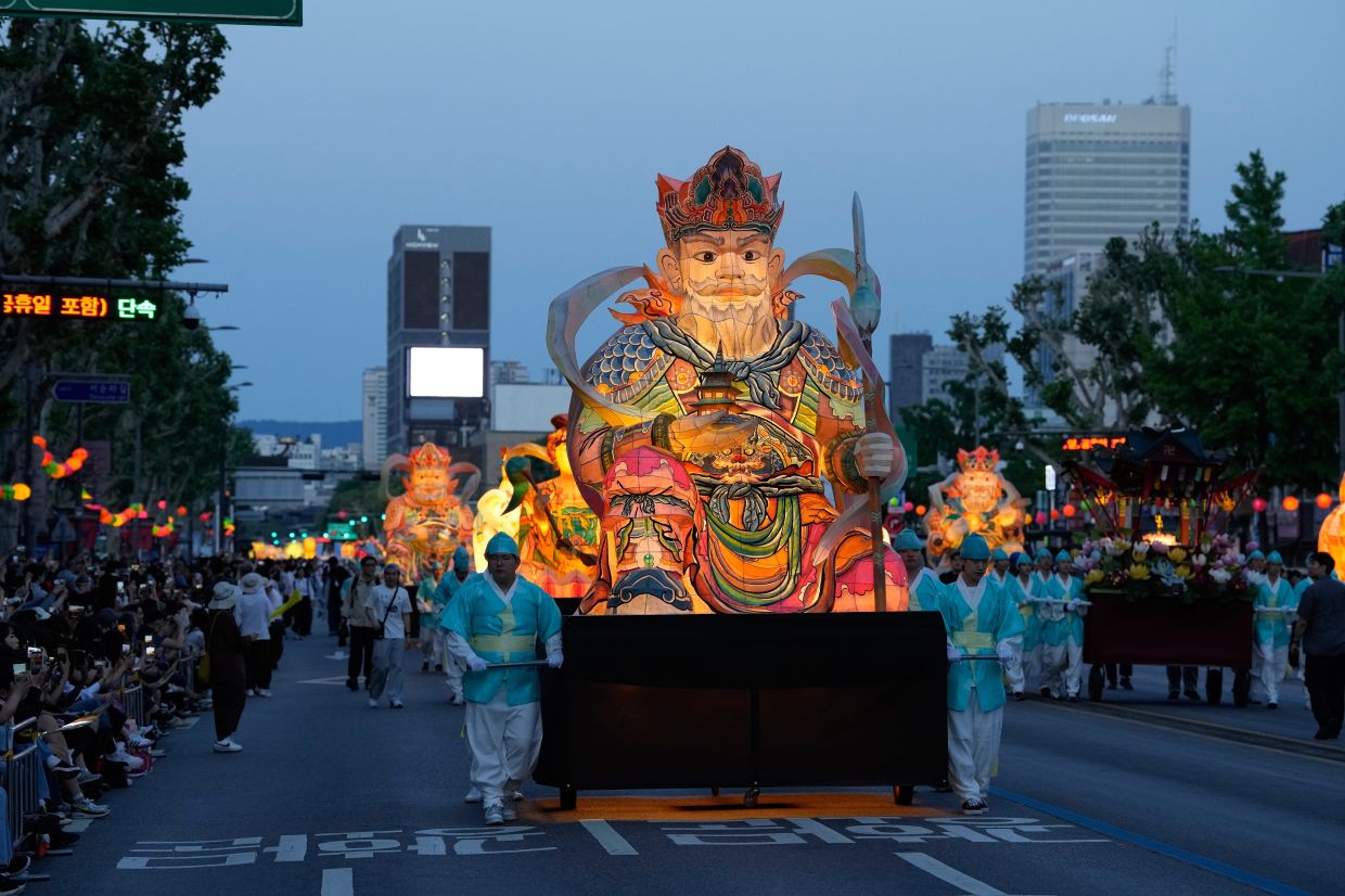 Buddhists with giant lanterns participate in a lantern parade during the Lotus Lantern Festival ahead of the upcoming birthday of Buddha, in Seoul, South Korea, Saturday, May 16, 2026.-- AP Photo/Ahn Young-joon