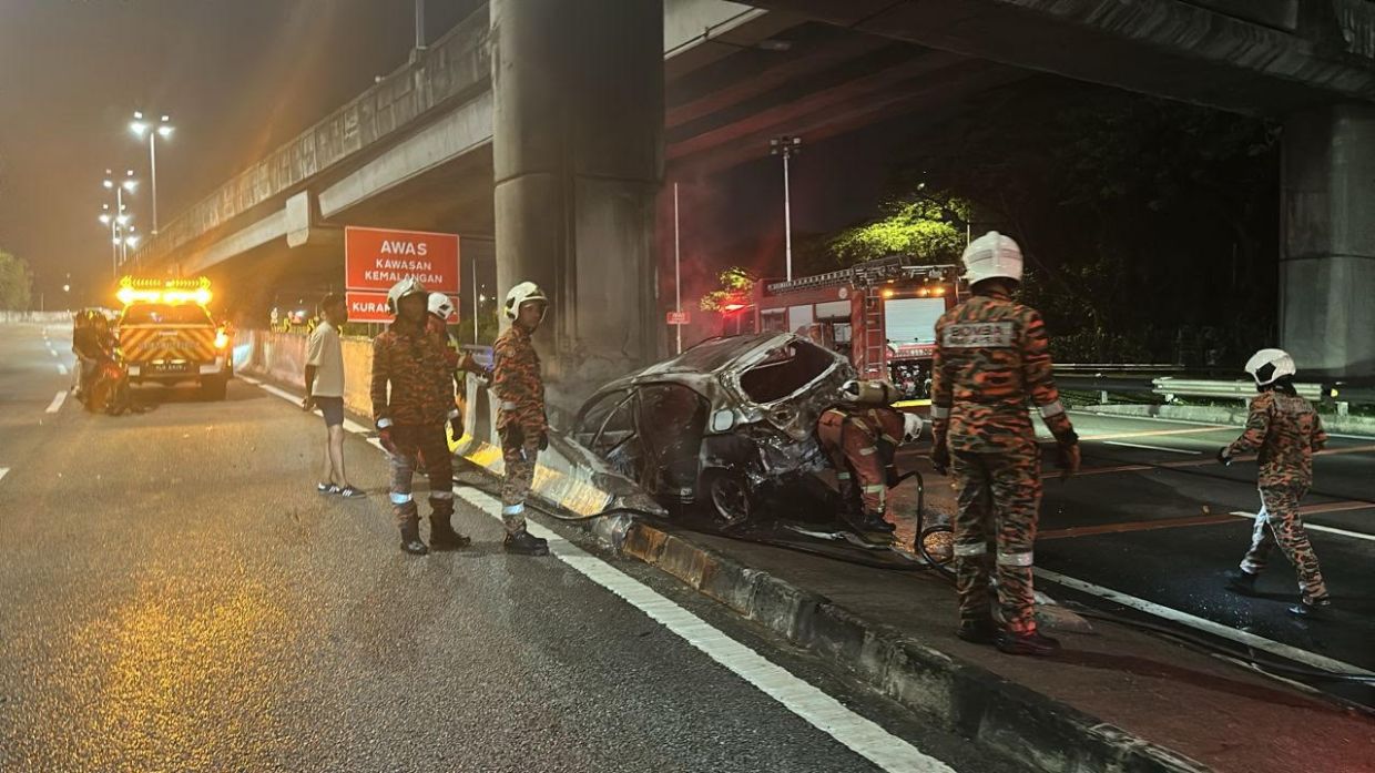 Two colleagues were killed after the car they were travelling in skidded, crashed, and burst into flames on Jalan Sungai Besi early Sunday (May 17).