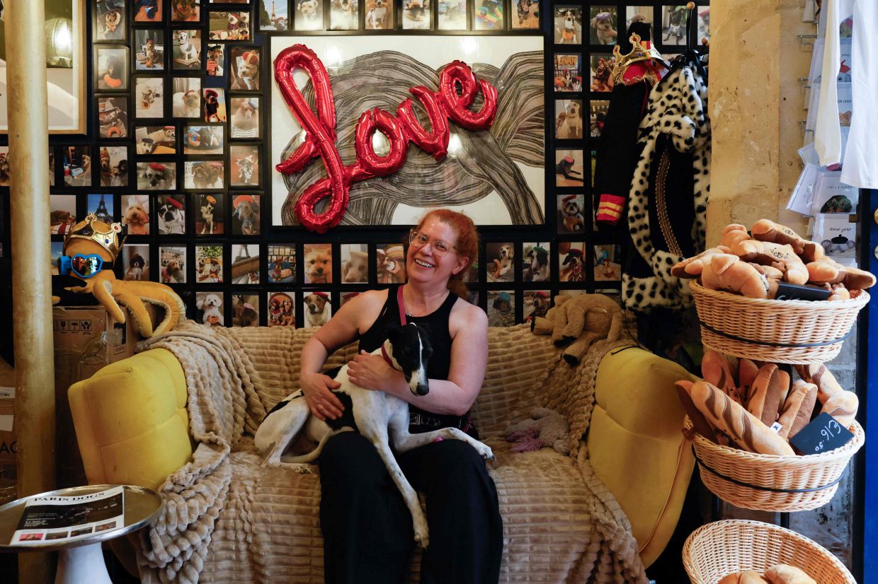 Owner of 'Le Bone Appart' Rebecca Anhalt poses with her dog Napoleon, a Whippet dog.