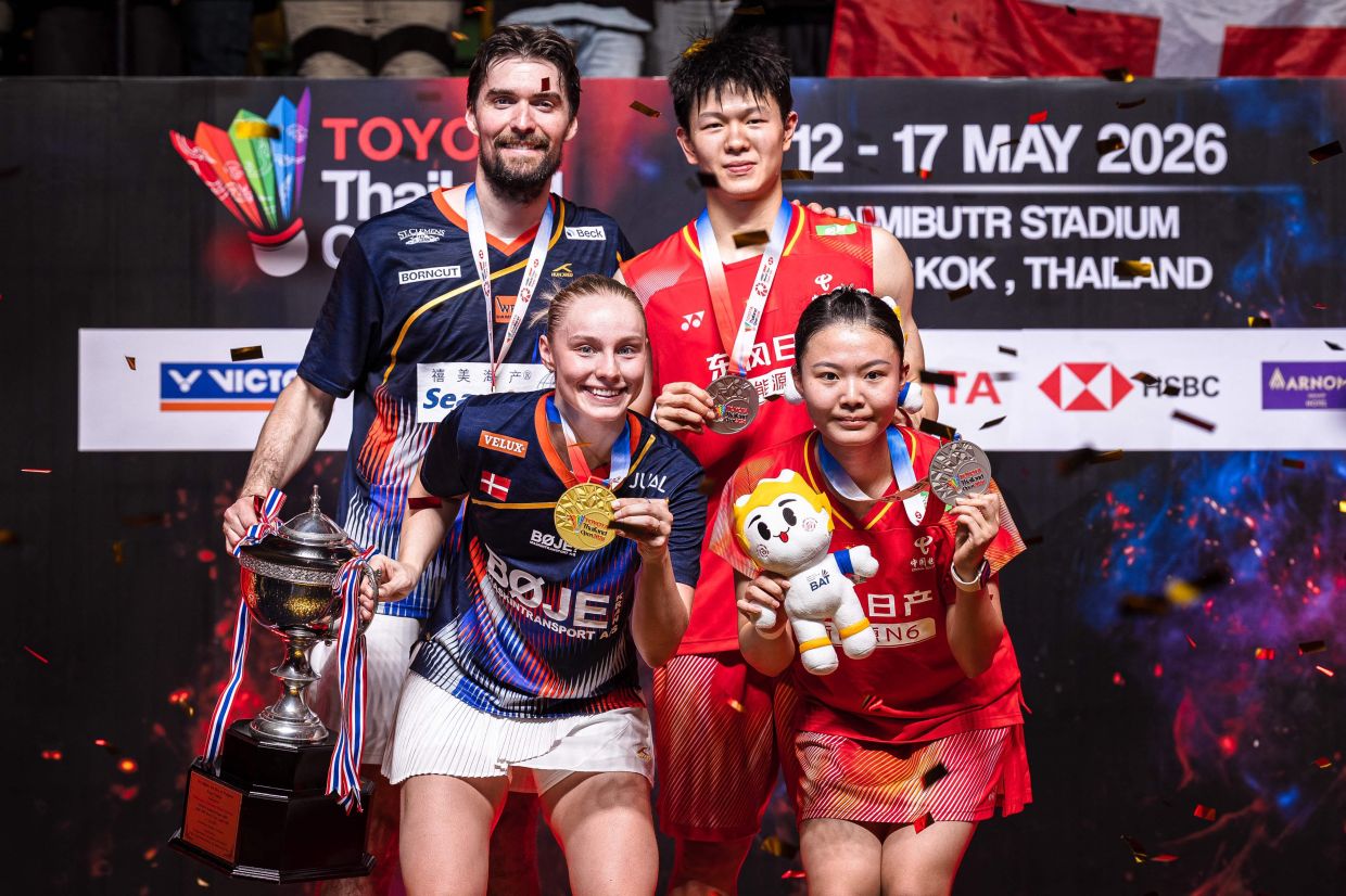 Denmark's Mathias Christiansen (top, L) and Alexandra Boje (bottom, L) pose with the trophy after their victory against China's Zhu Yijun (top, R) and Li Qian in their mixed doubles final match at the Thailand Open badminton tournament in Bangkok on Sunday, May 17, 2026. -- Photo by Chanakarn LAOSARAKHAM / AFP