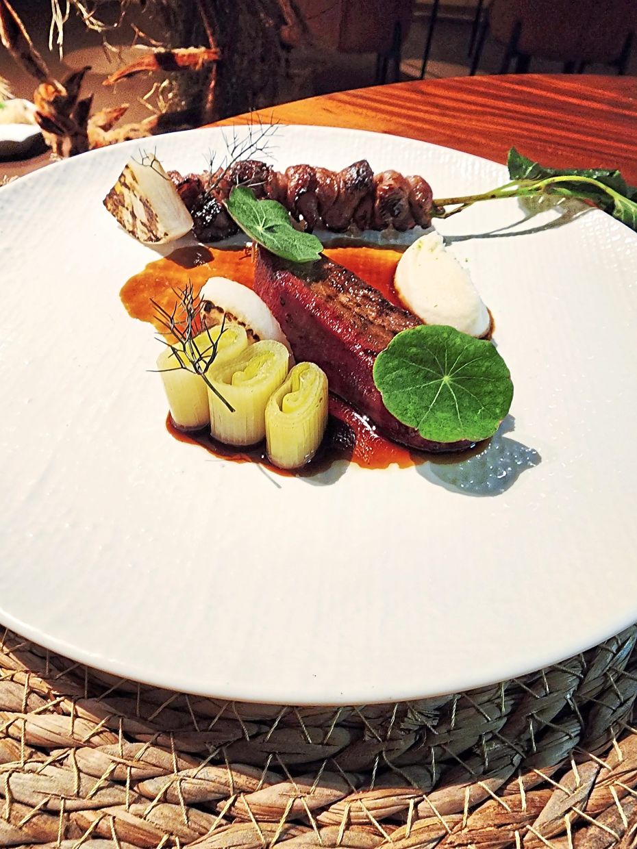 The Land course features wagyu and grilled beef tongue, with beef bosou jus, leeks, daikon and heart of palm puree.