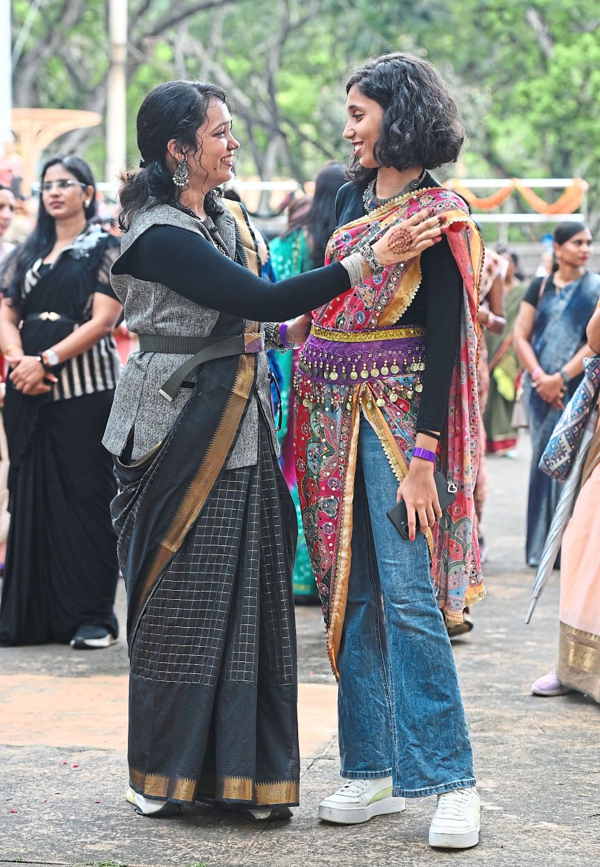Shwetha (left) and Pratyusha putting a fusion spin on the saree. (Below) Lim finds the saree comfortable even for Zumba.