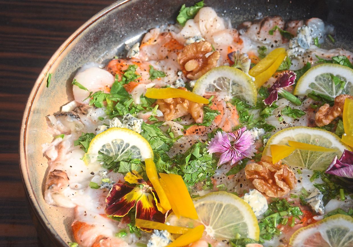 Lobster Carpaccio with Walnut, Blue Cheese and Yellow Pepper.