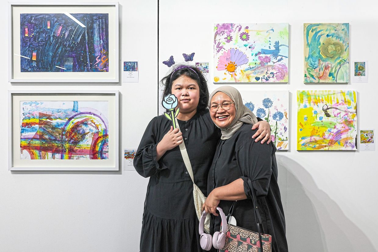 Dhia, pictured with mother Mariena, has found her passion in creating galaxies from her imagination.