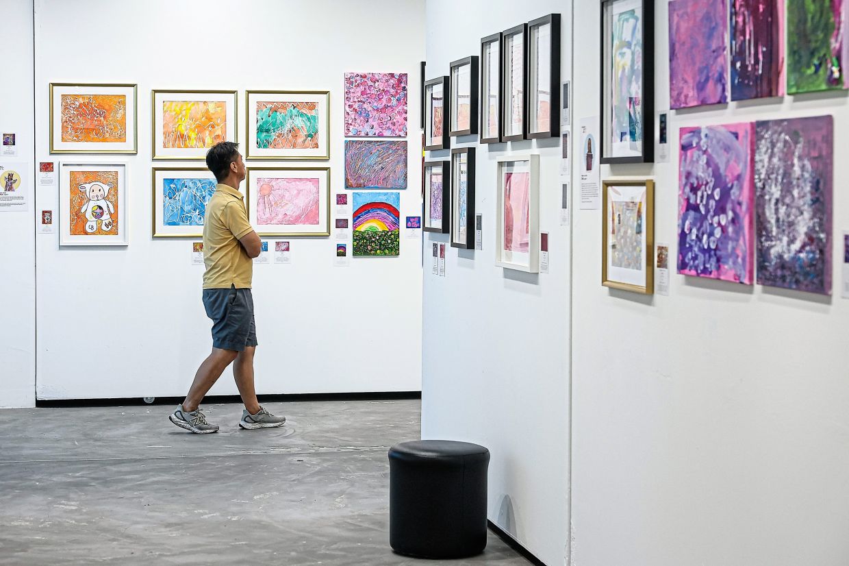 A visitor admiring works at Seni Mekar: Art in Bloom, which runs at Ken Gallery in Kuala Lumpur until May 18.