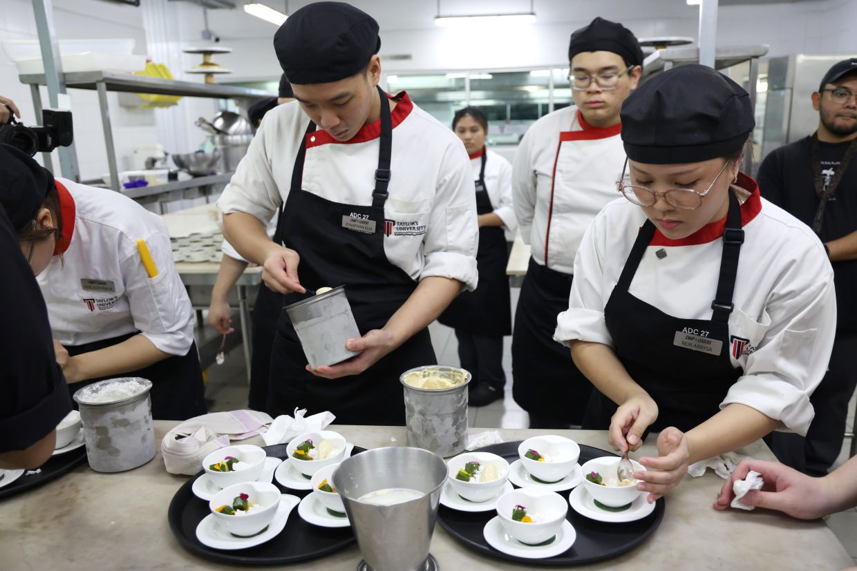 (Right) Nur Arrysa preparing the dessert course alongside her fellow students as part of the COL masterclass. — GLENN GUAN/The Star