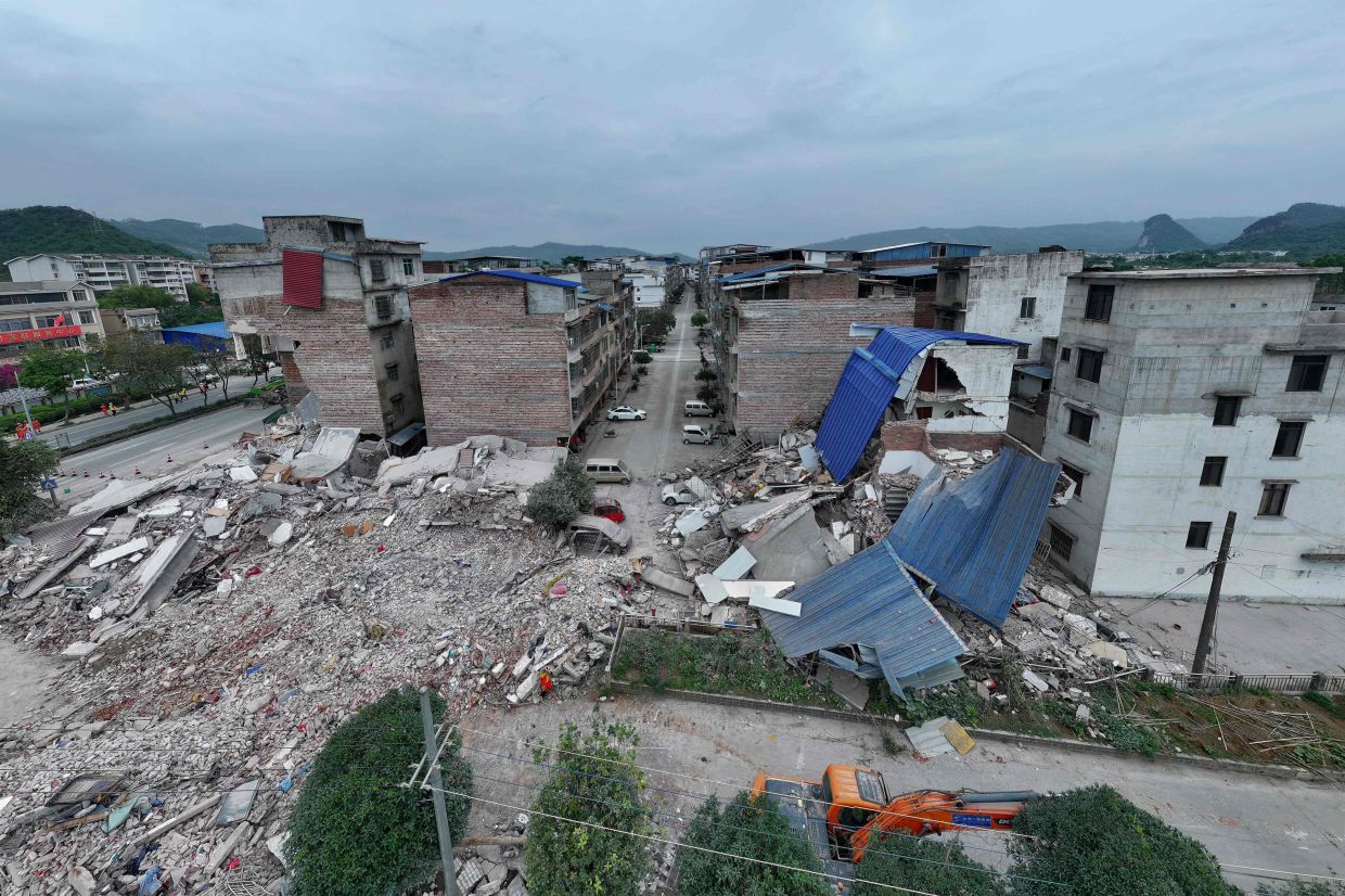 This photo shows a general view of collapsed buildings after an earthquake at Liunan district, in Liuzhou, China's southern Guangxi region on May 18, 2026. A 5.2-magnitude earthquake struck south China's Guangxi region on May 18, killing two people and causing 13 buildings to collapse, state media reported. -- Photo by CN-STR / AFP