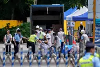 ‘Heavy’ hearts as residents of Wang Fuk Court’s only spared block return again