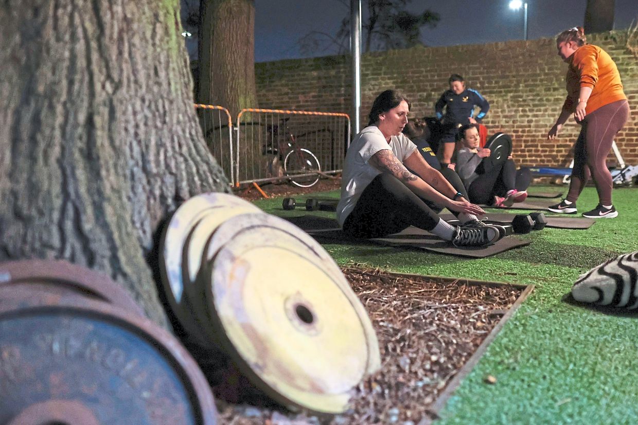 Chloe Spriggs (left) takes a moment as members of Teddington women's rugby team use weights as they train at the club house in London. Resistance training has been found to help prevent heart disease, improve long-term mobility and lower blood pressure.
