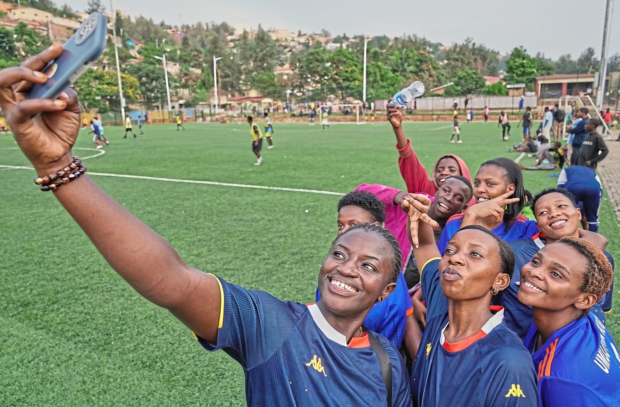 Soccer players on the Rwanda Amputee team pose for a selfie after a training session in Kigali, Rwanda. Photo: AFP