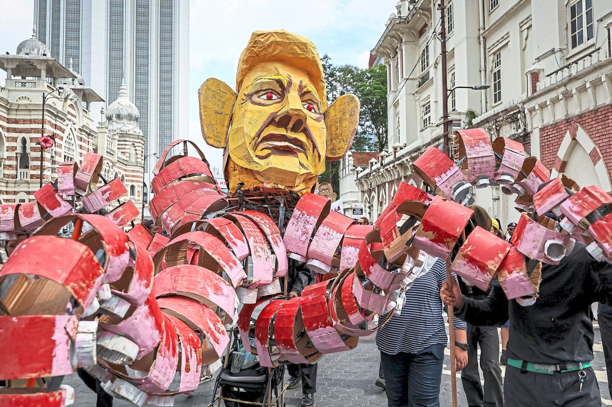 A large effigy of US President Donald Trump is carried through the crowd during a May Day rally in Kuala Lumpur, underscoring political and economic grievances. — Reuters