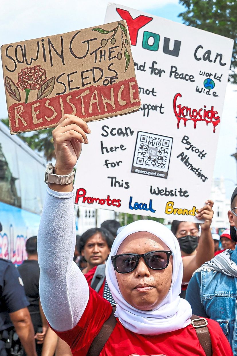 Protesters displaying a placard reading ‘Sowing the seeds of resistance’ as they call for reform, resistance and peace during the May Day rally. — Reuters