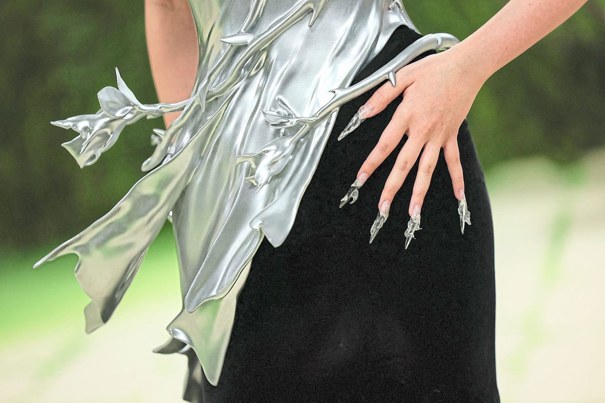 Fashion designer Grace Ling a sculptural creation of her own design featuring a chrome-finished, 3D-printed aero-aluminium bodice inspired by Salvador Dali’s ‘The Persistence of Memory’. The Singaporean also tailored her nails to mirror the surreal, liquid-metal aesthetic of the futuristic gown. — Reuters