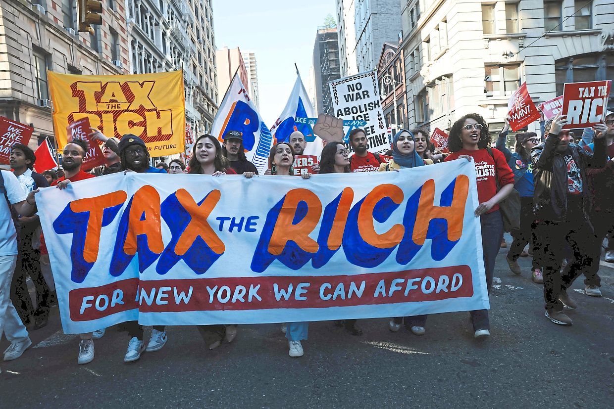 Protesters marching through lower Manhattan calling for better wages, working conditions and political reform during an International Workers’ Day rally in New York City, the United States. — Getty Images/AFP