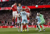 Soccer-Arsenal edge closer to league title with narrow win over Burnley