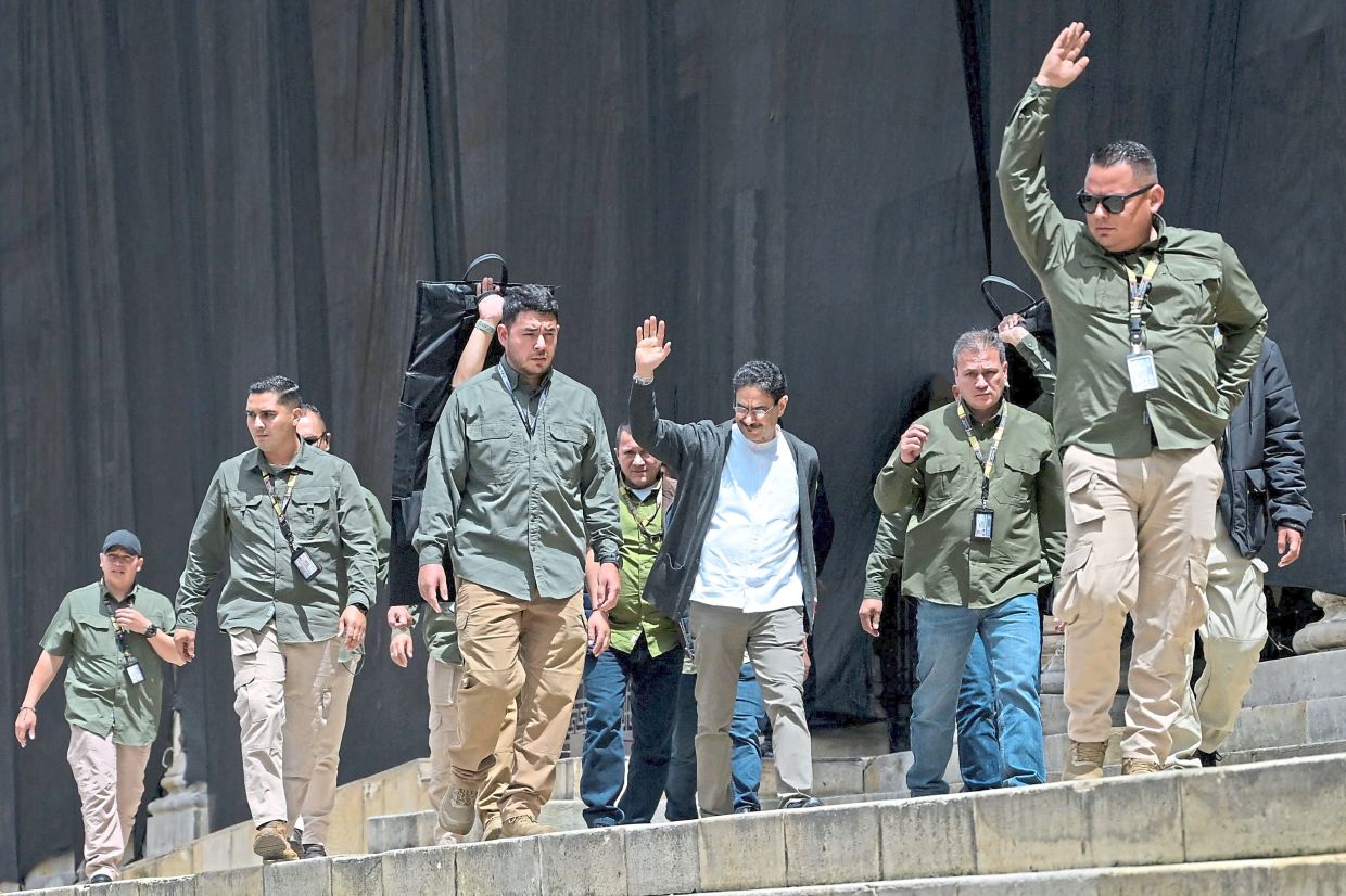 Colombia's presidential candidate from the ruling party Pacto Historico, Ivan Cepeda (C), waves to supporters during a May Day rally marking International Workers Day, in Bogota on May 1, 2026. (Photo by Raul ARBOLEDA / AFP)