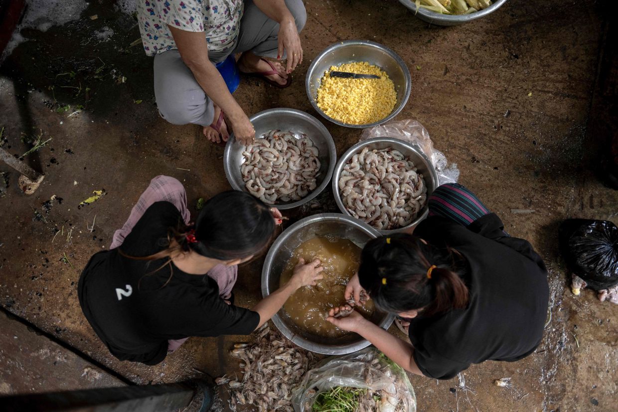 Workers prepare to cook dishes at a Rakhine traditional food restaurant in Yangon.