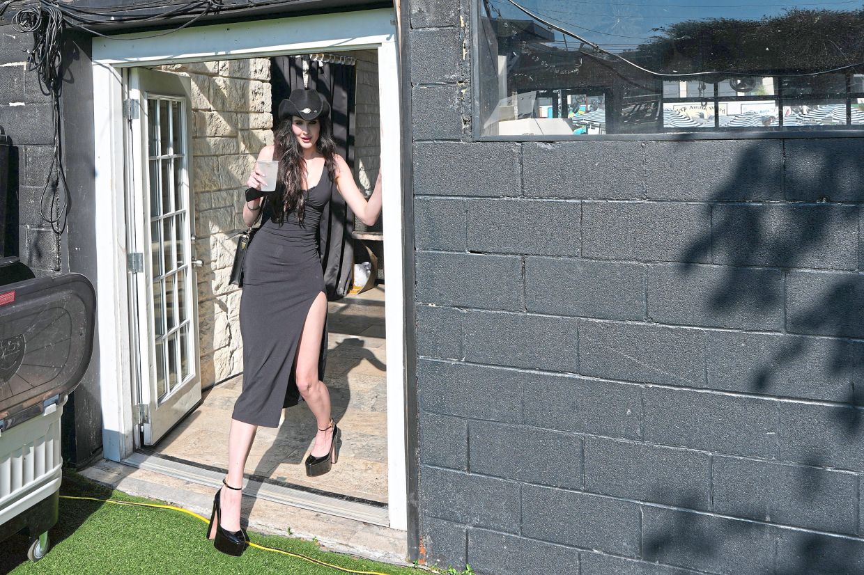Zoe Raabe ducks as she passes through a doorway.