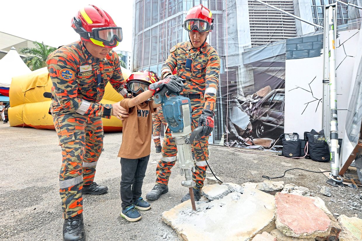 A child learning about a power tool commonly used during rescue operations.