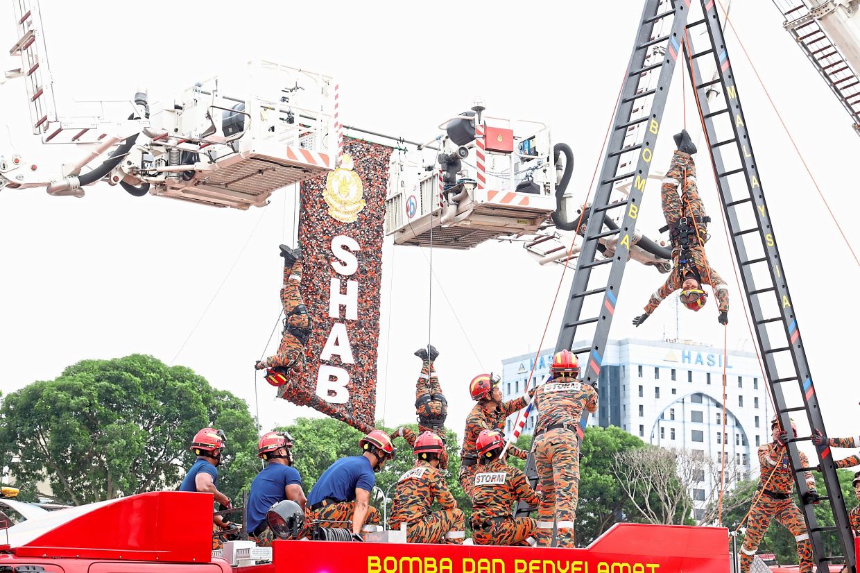 A firefighter demonstrating an inversion manoeuvre as part of their rope skills.