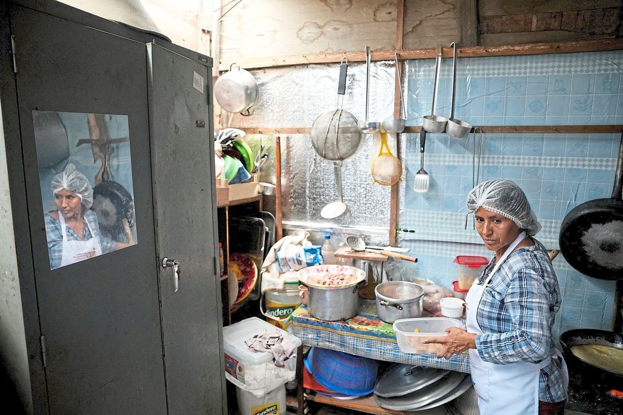 Lopez preparing food at a community soup kitchen in the shantytown. — Reuters 