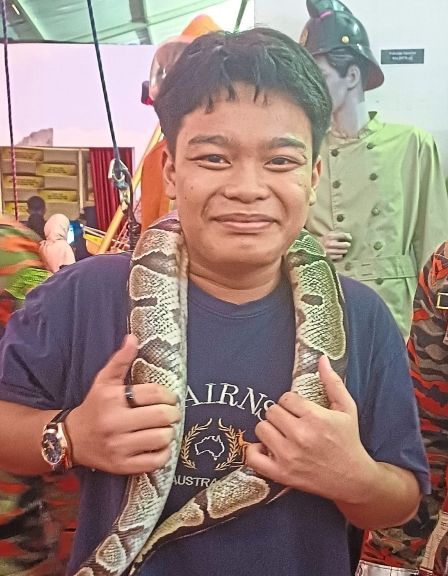 Aminul Danish bravely draping a python over his shoulders.