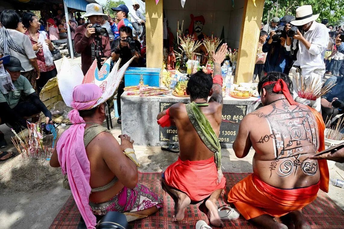 Cambodian revellers praying to the guardian spirit Pring Ka-Ek on the outskirts of Phnom Penh on May 21. - Photo: AFP