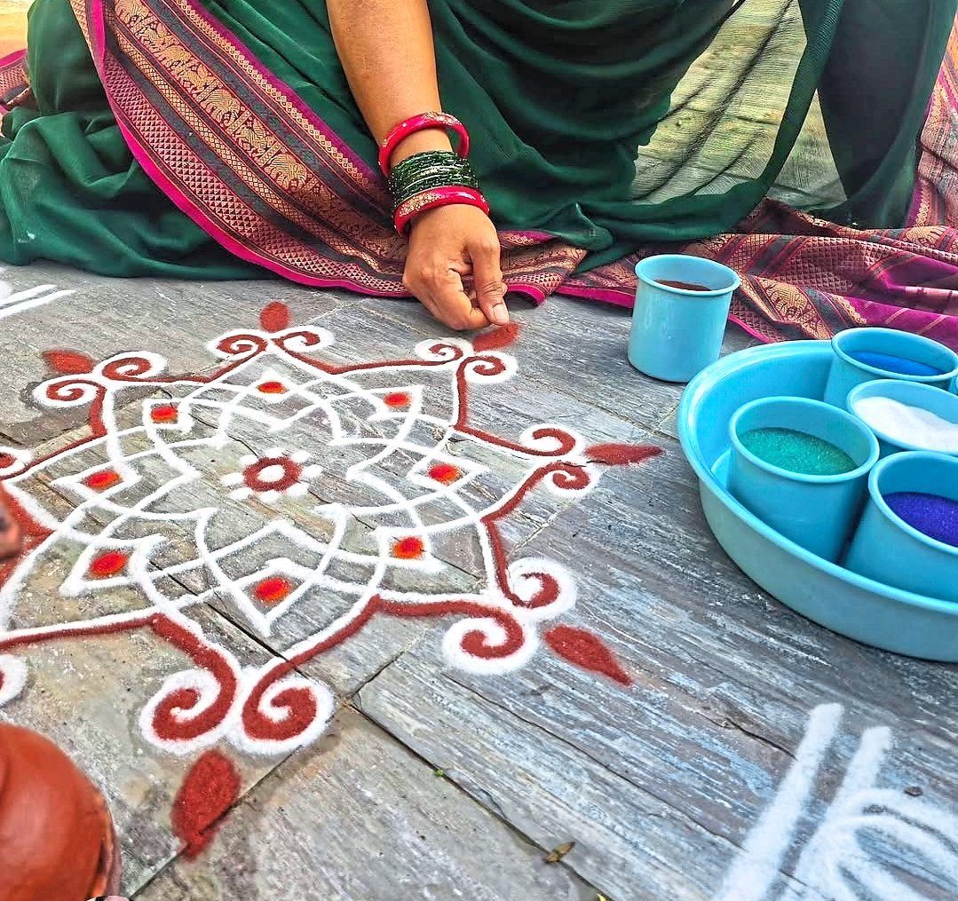 Red ochre powder, known as kaavi podi, is believed to symbolically protect the home and safeguard those who live within it.