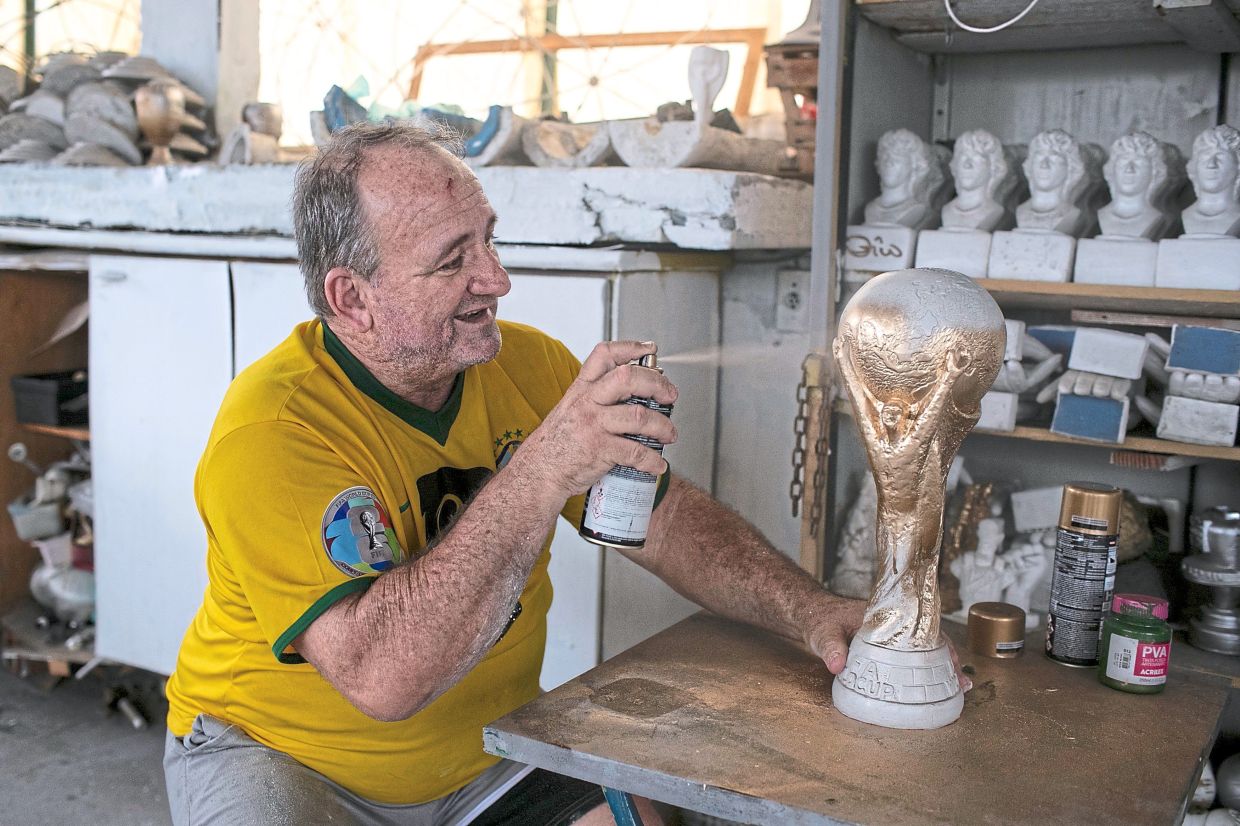 The replica World Cup trophies are made by hand from moulds and finished off with paint.

They range in size and price from about US$1 (RM3.97) to US$100 (RM397).