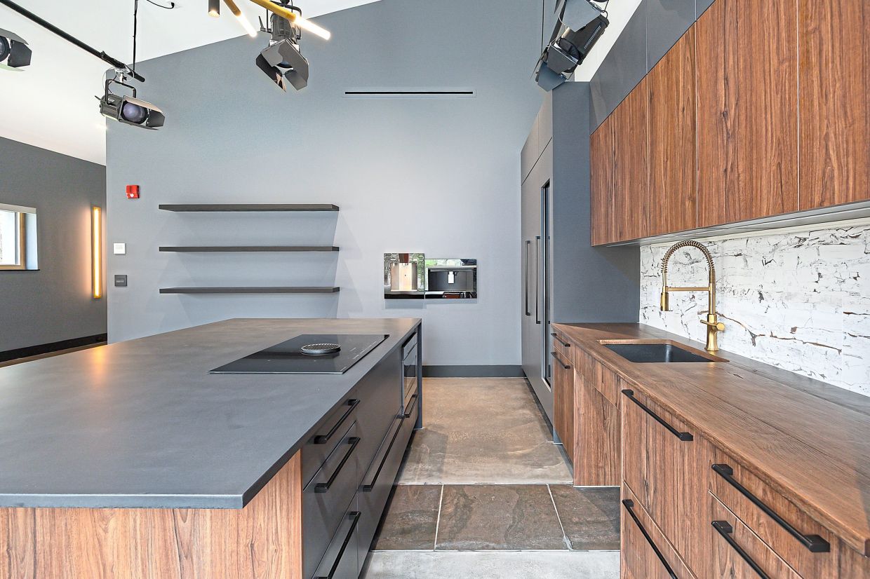 Two tone cabinetry creates an ultra-modern look in this industrial space.