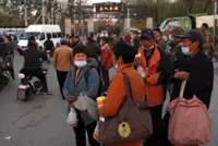 China signals it will relax household registration restrictions