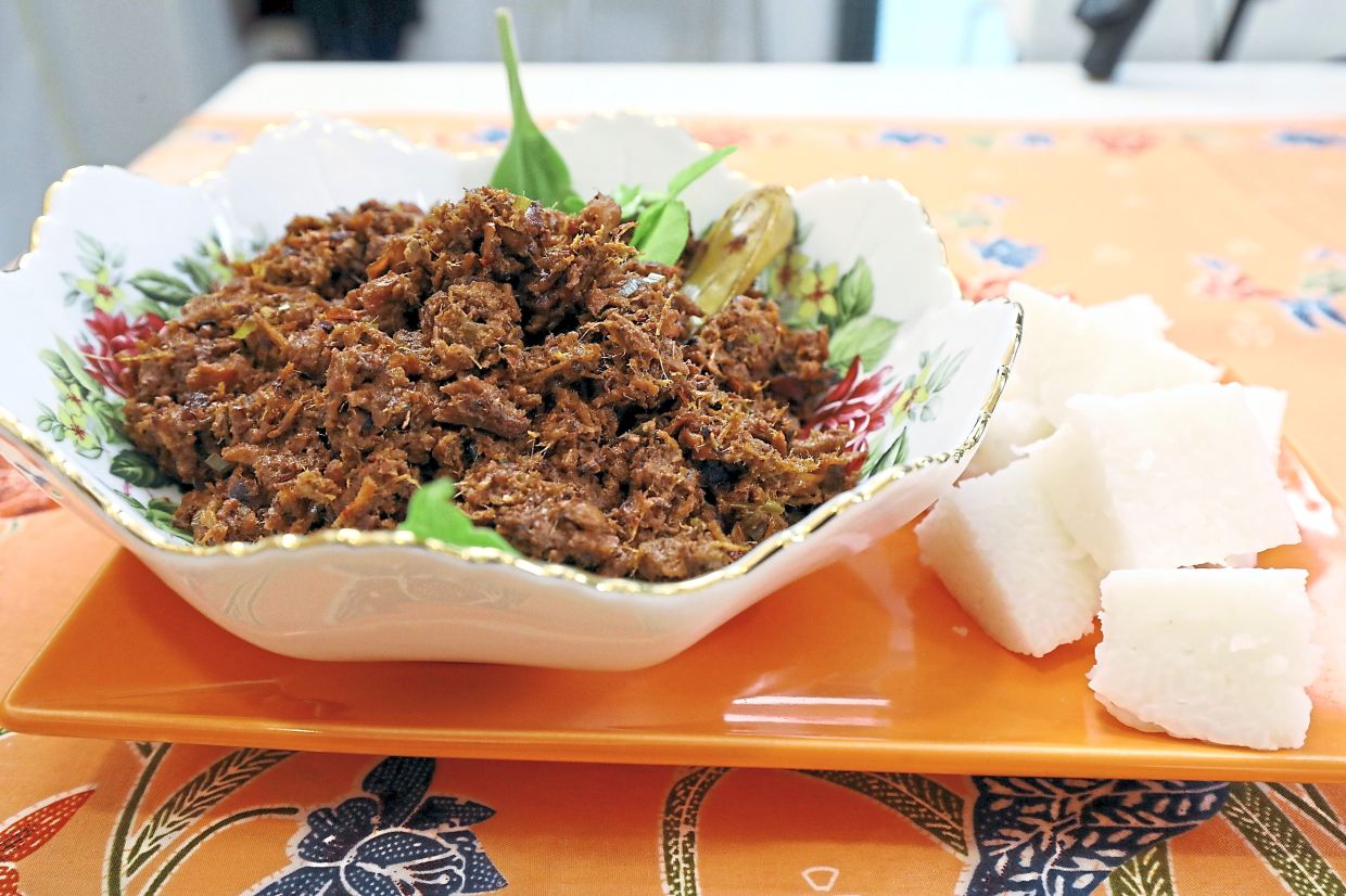 Rendang Minang is cooked slowly until the coconut milk fully reduces and coats the beef in a dark, intensely flavoured rempah. Photos: AZLINA ABDULLAH/The Star