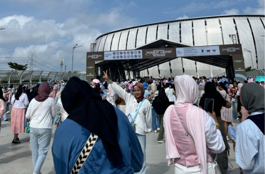 Concertgoers posing in front of the entrance gate to the Jakarta International Stadium in North Jakarta. - Supplied