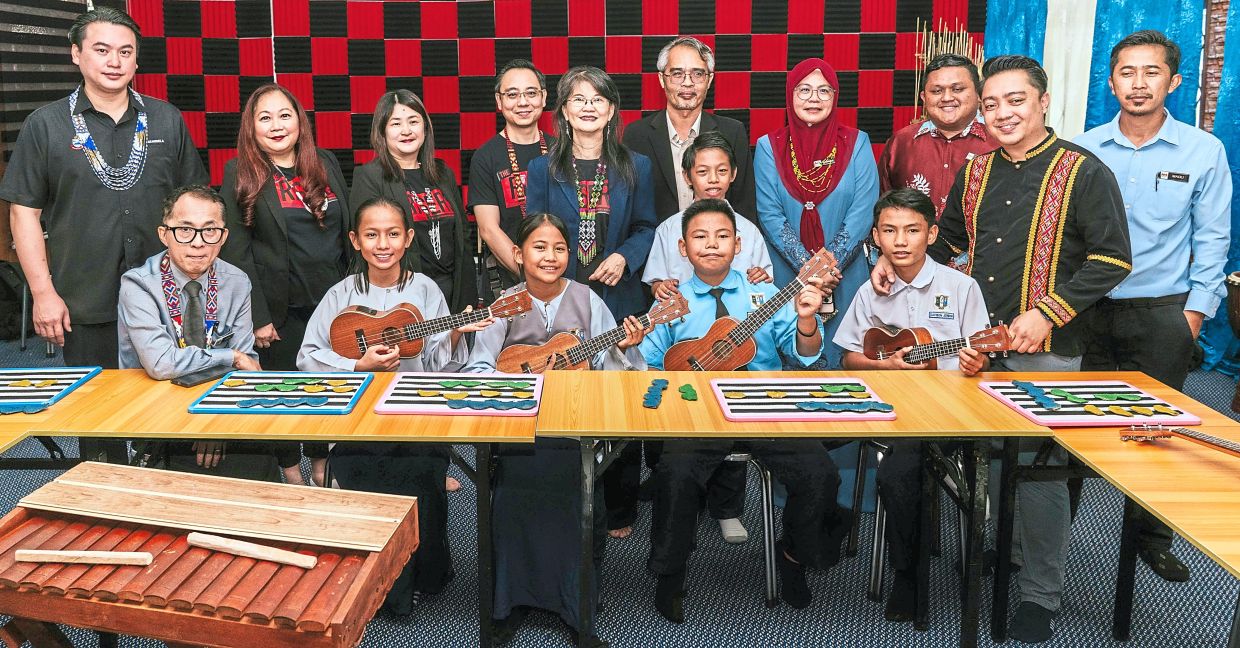 Breaking barriers: Stefanus (standing, second from right) and Tan (standing, fifth from left), together with pupils with disabilities, in the upgraded inclusive music room at SK Pendidikan Khas Kota Kinabalu. With them are Sabah education representatives.