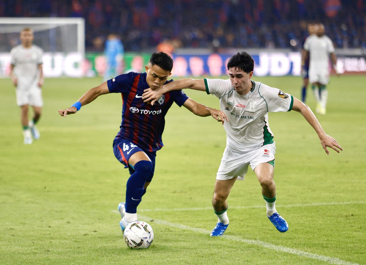 JDT’s Arif Aiman (left) fight for the ball with Kuching City’s Scott Philip Galang Woods during Malaysia Cup final match between JDT and Kuching City at National Stadium, Bukit Jalil. — FAIHAN GHANI/The Star