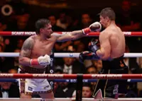 Boxing-Usyk avoids shock defeat with 11th round stoppage of Verhoeven
