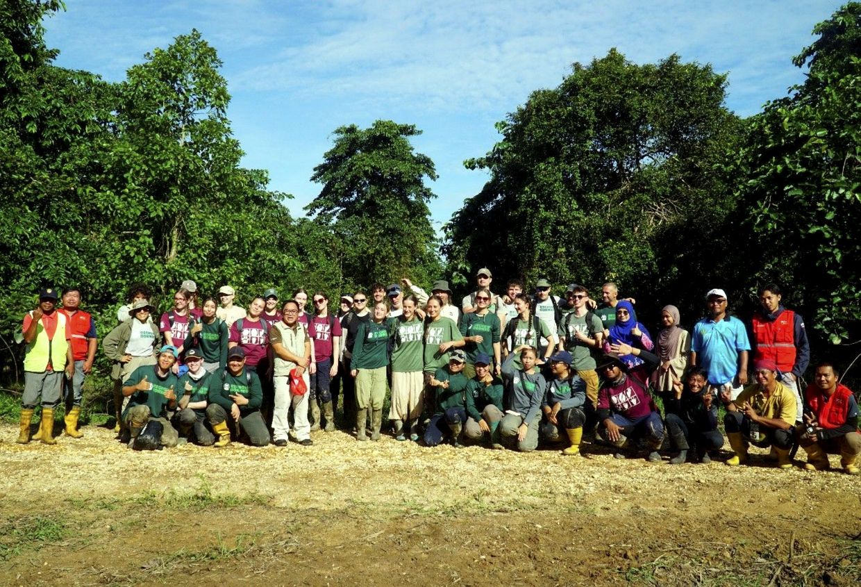 A group posing for a photo after a tree planting activity.