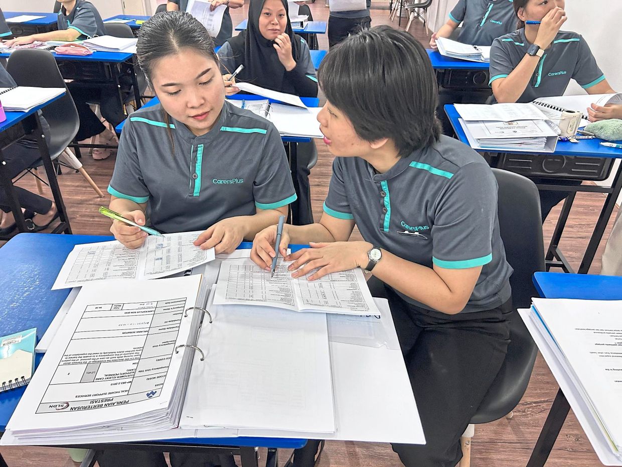 Cohort 1 trainees of CarersPlus Asia attending a revision session after returning from workplace learning assignments in Kuala Lumpur ahead of their final SKM-3 examination.