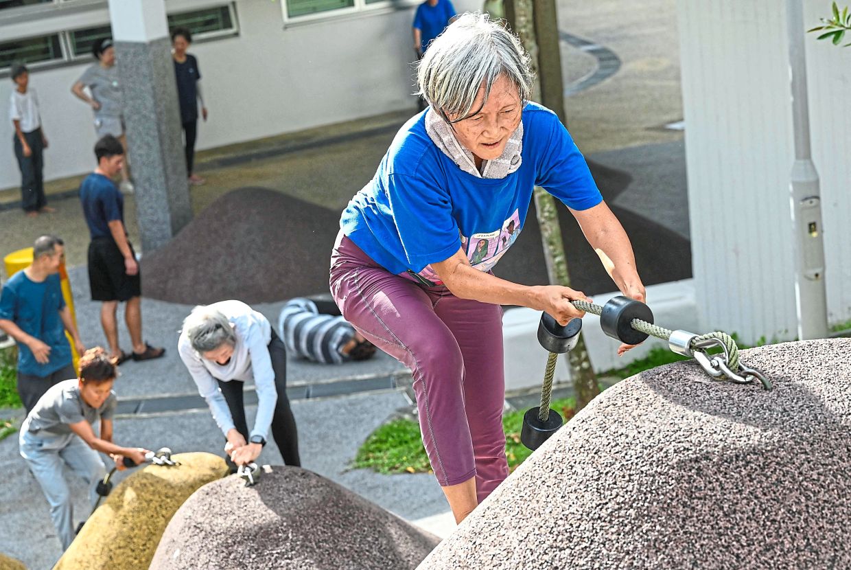 We got this: Singaporean elders taking part in a parkour training session. Around 20 retirees learned to tackle a series of relatively demanding exercises, building their agility and enjoying a sense of camaraderie. — AFP 