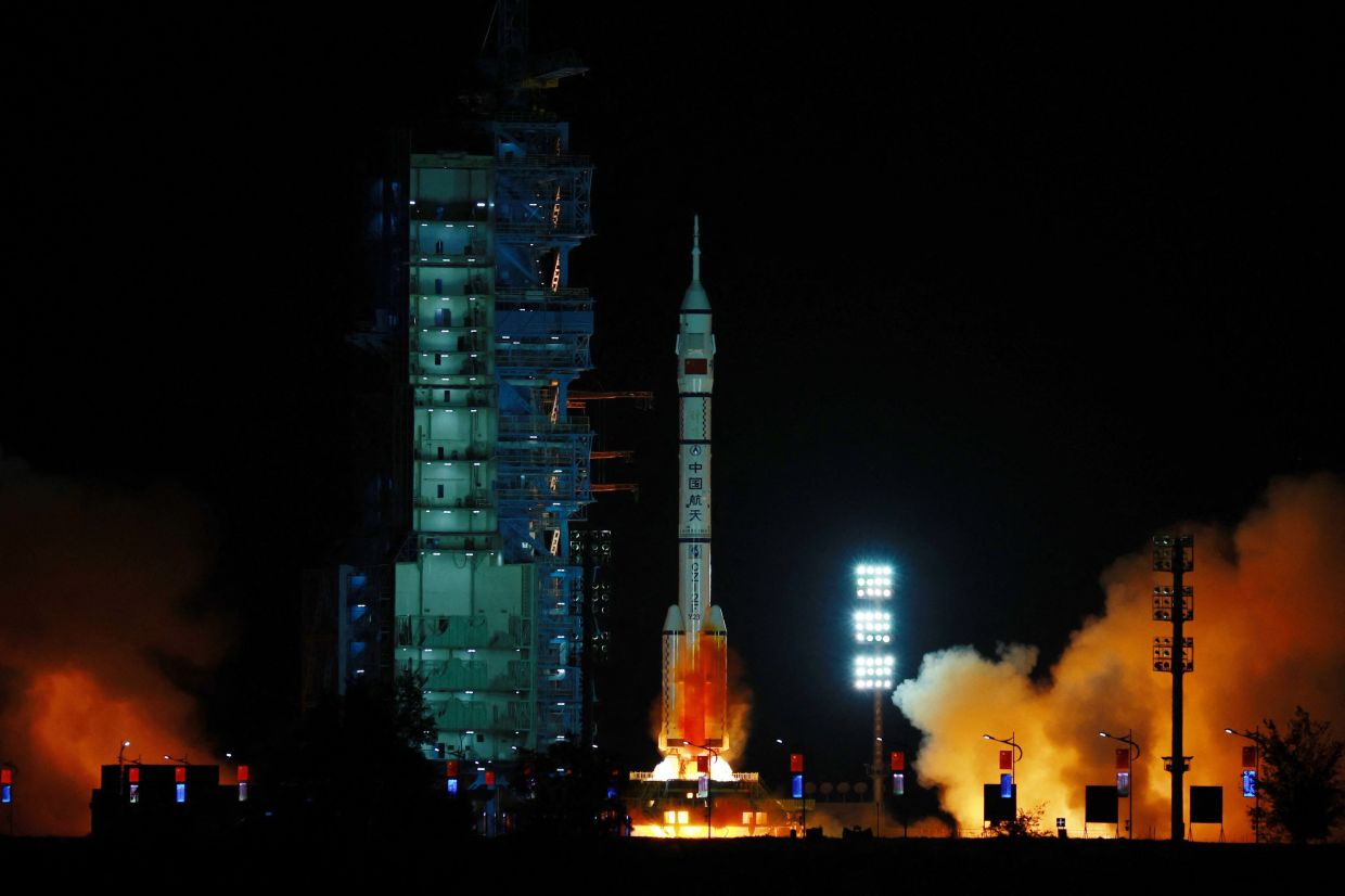 A Long March-2F carrier rocket, carrying the Shenzhou-23 spacecraft and a crew of three astronauts, liftING off from the Jiuquan Satellite Launch Centre in the Gobi desert, northwestern China on May 24, 2026. - AFP